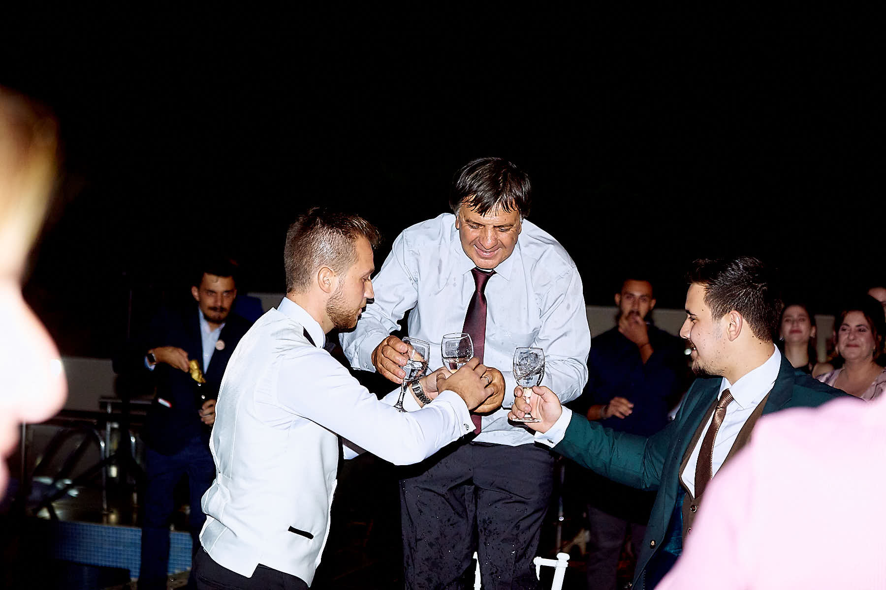 Groom and relatives with drinks