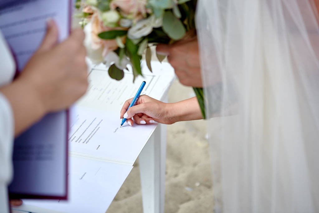 Bride signing papers