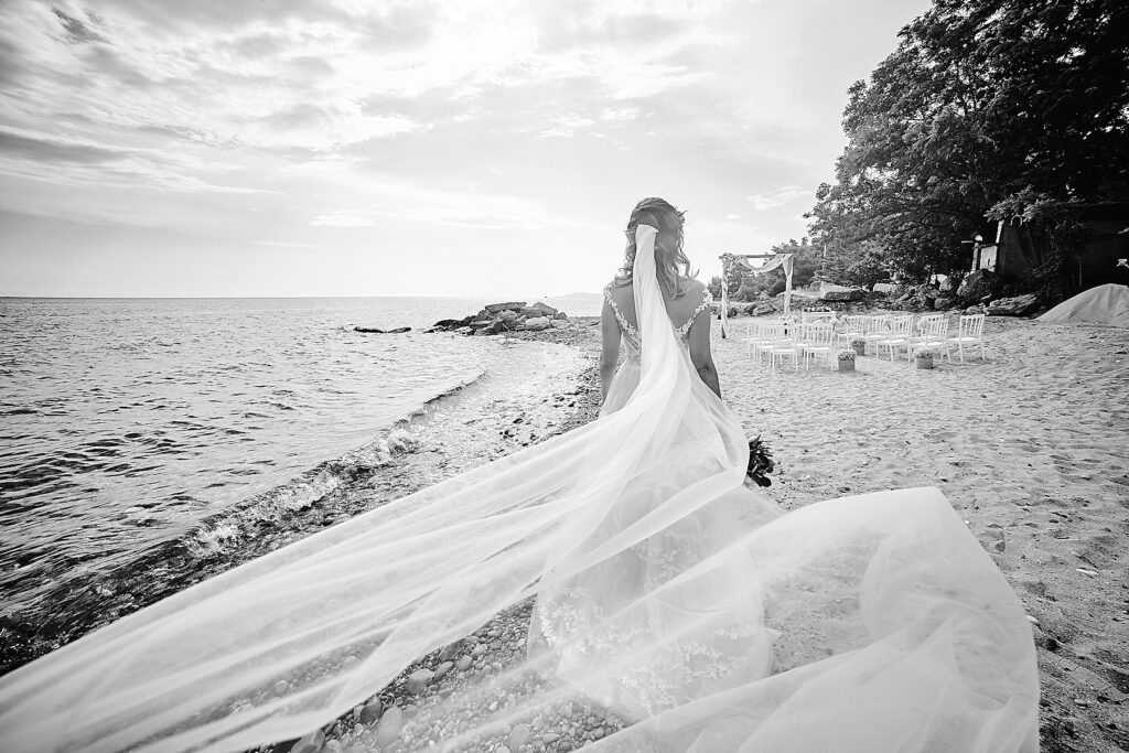 (black and white) Bride walking at the beach in Halkidiki 