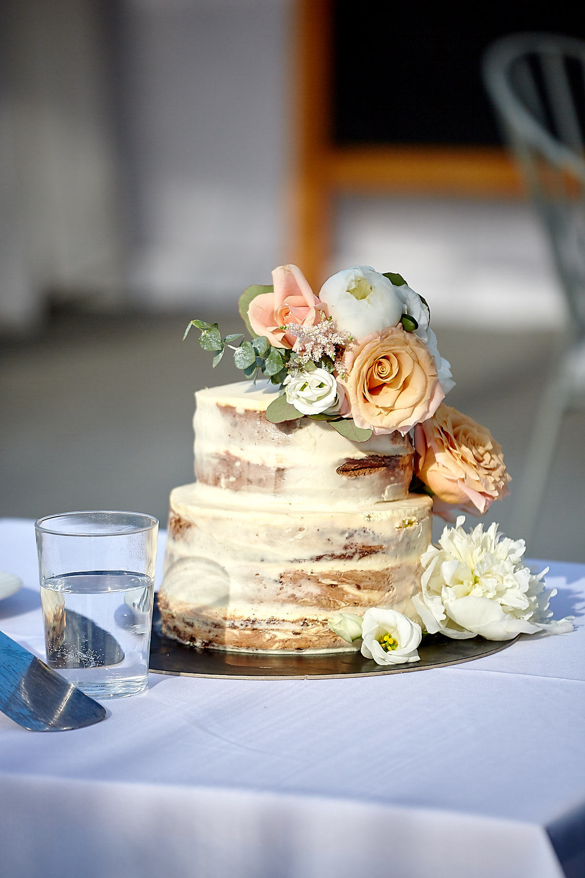 A two layer wedding cake decorated with flowers