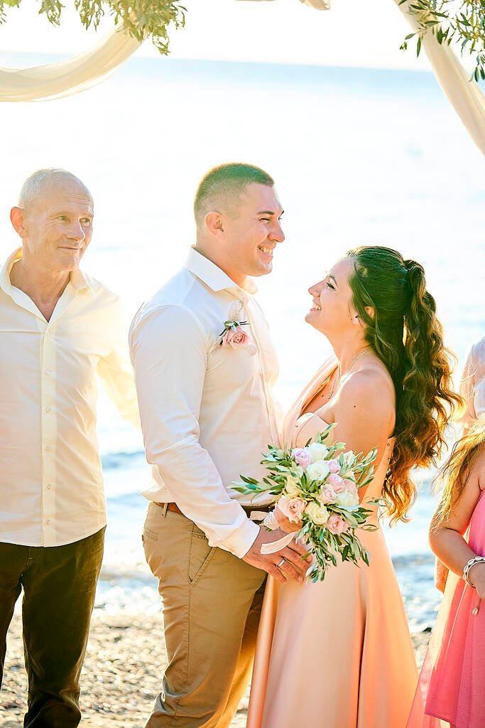 Groom hugging bride gently