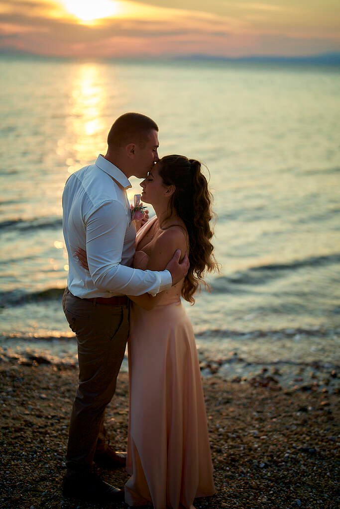 Wedding kiss by shoreline