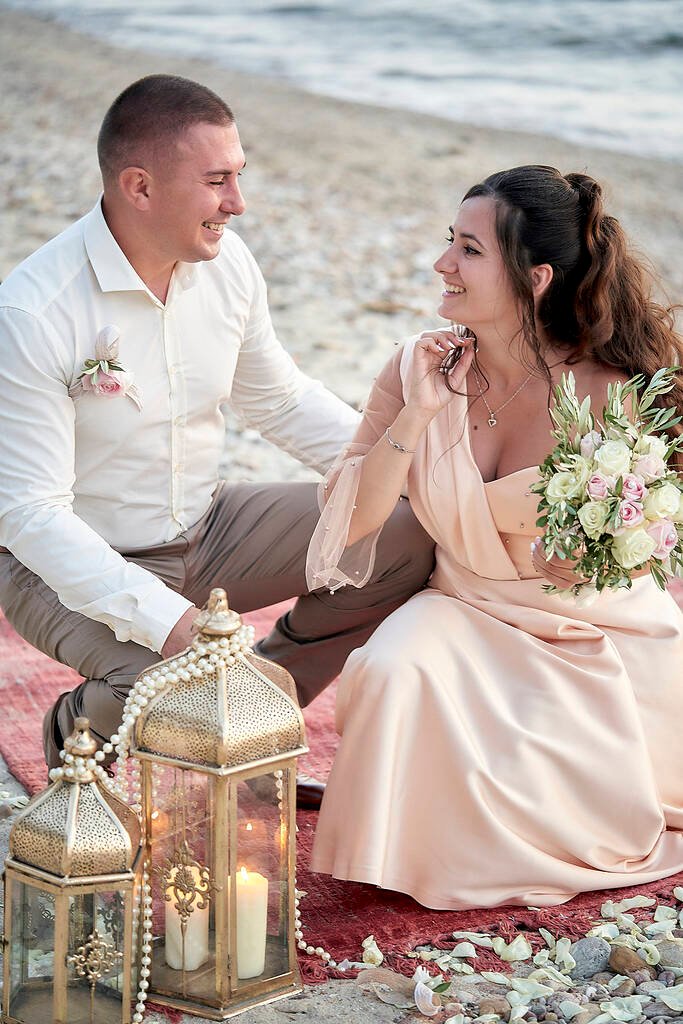 Couple sitting on sand