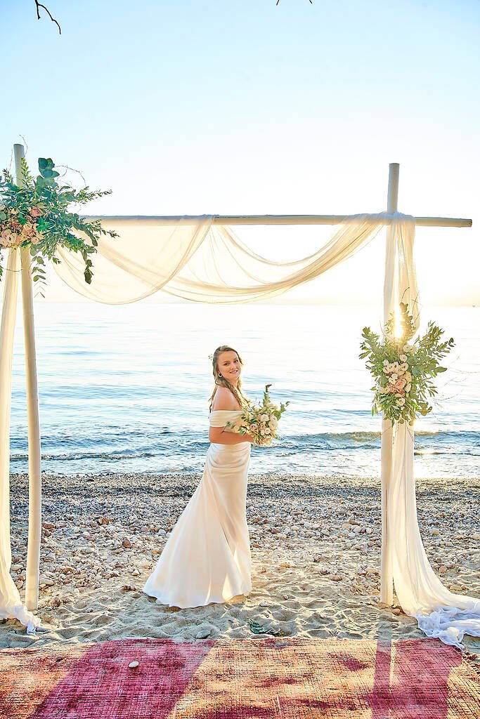 bride laughing on beach