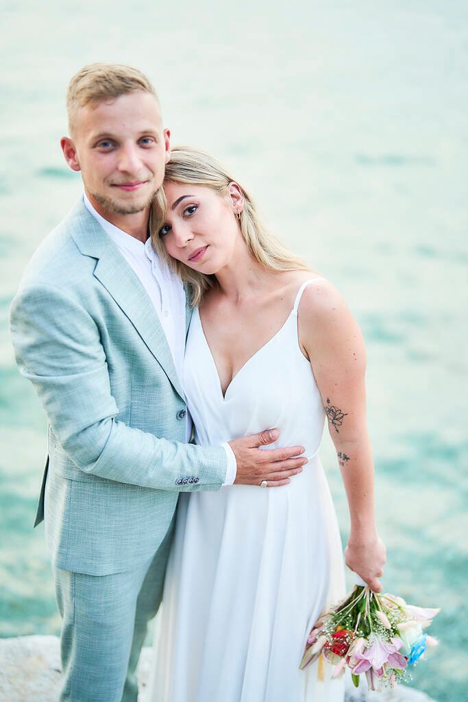 Bride and groom beach walk