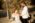 Groom touching his bride's arm , wife sitting on a boat holding flowers