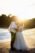 groom kissing brides cheek by the beach