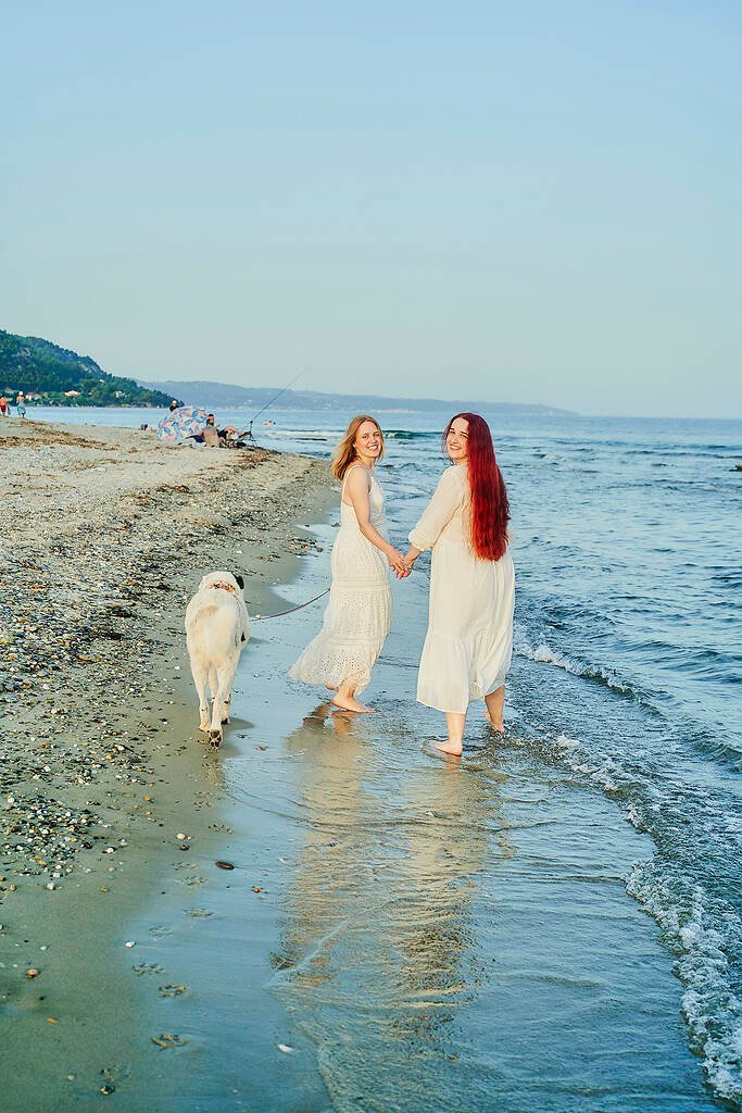 Same-sex couple walking beach