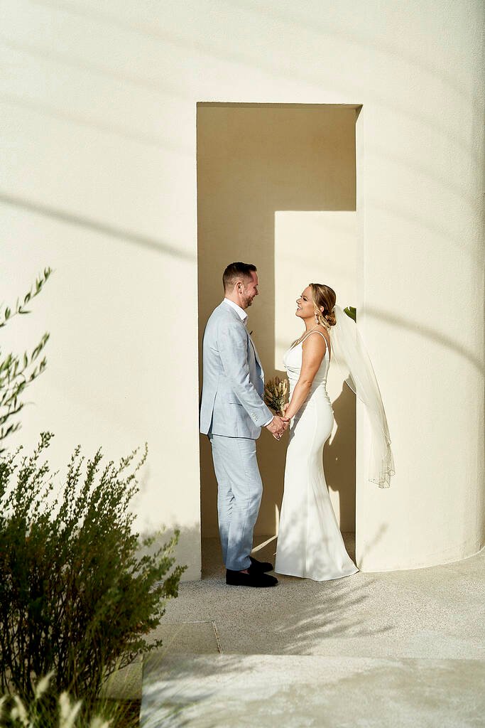 Bride and groom holding hands in Greece